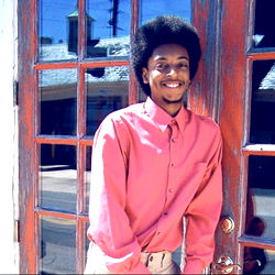 ApolloTheAlmighty in a Pink Shirt and Afro