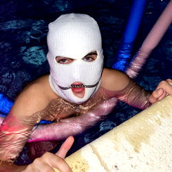 Mysterious Figure in Mask Swimming in Pool