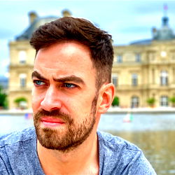 Blue_eyes86, a model from Italy, posing in front of a historic building.