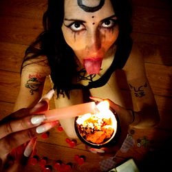 Model in a Dark Room with Candles and Tattoos