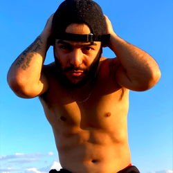 Fitness model striking pose on beach