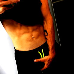 Fit Model Showcasing Abs in Sports Wear