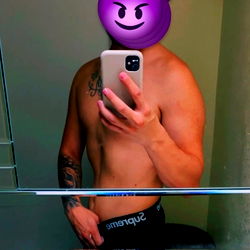 A Shirtless OnlyFans Model in a Bathroom Mirror