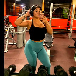 Fitness Model in Gym Mirror with Tattoo and Headphones