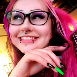 DeadRX, OnlyFans Model, Smiling at Camera with Pink Hair and Glasses