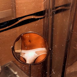 A Bathroom with a Mirror and Shower Curtain