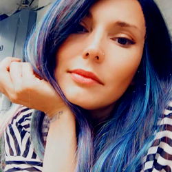 Angel, the onlyfans model with unique and vibrant blue hair,