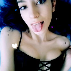 Model in Black Leather Lingerie on a Bed