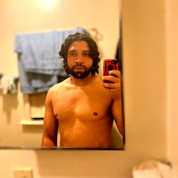 Shirtless Man in Bathroom Mirror