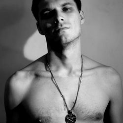 Jerry Smith, a model for OnlyFans, striking an intense pose in a black and white photograph.