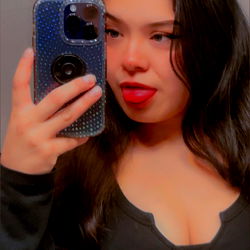 A California-based OnlyFans model taking a selfie with a blue phone