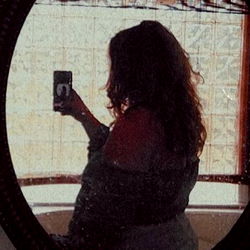 Reina, a Model Reflecting in an Oval Mirror