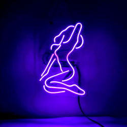 Purple Neon Sign of a Mermaid in a Bikini Hanging on Wall