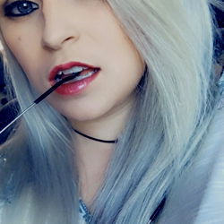 Ariel, the OnlyFans model with white hair and a black cat