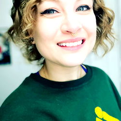 A Smiling Woman in a Green Sweater Posing for the Camera