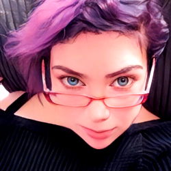 Person in Purple Hair and Glasses