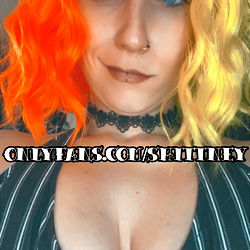 Model pose in vibrant red and orange wig