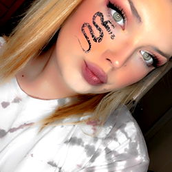 Young Adult Woman with Tie-Dye Tee Shirt and Makeup, Possibly Influencer or Model Role