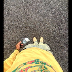 Person in Yellow Skate Shirt with Flask