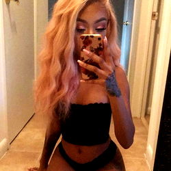 Artistry, an OnlyFans Model, in a Black Tank Top and Pink Hair