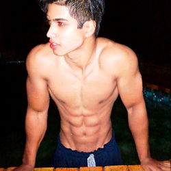 Fit Model Wolfie Showing Abs and Bravado in Poolside Shoot