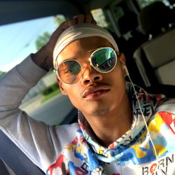 Relaxed Young Man in Sunglasses, Shirt and Cap, Taking a Break