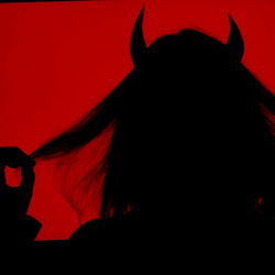 Attractive Model in Disturbing Costume with Red Background