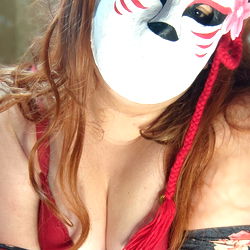 Artemis, OnlyFans model in masquerade attire,