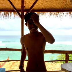 An Exotic Getaway: A Man Poses for a Selfie at a Beachside Bar in Thailand
