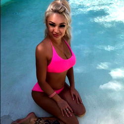 Anna, a Fitness Model in Pink Bikini Sitting Poolside