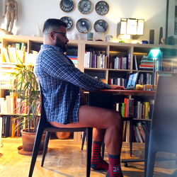 A Model Sitting at a Desk in a Living Room