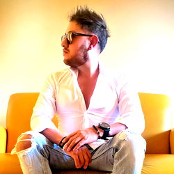 Fashionable Man in White Shirt and Sunglasses, Casual Pose with Hands in Jeans Pockets