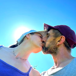 Couple sharing a tender moment under the sun