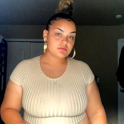 OnlyFans Model Arabmami21 in Crop Top and Denim Skirt Posing for Photo