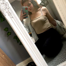 Young Woman Posing in Bathroom Mirror