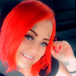Gorgeous Red-Headed Woman with Tattoos and Makeup