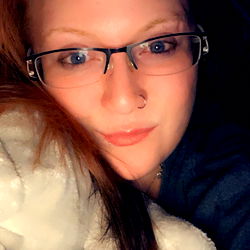 Model Thick Red from Edmonton, Sitting on Couch with Blanket