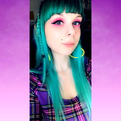 Stylish Female with Turquoise Hair and Colorful Eye Makeup