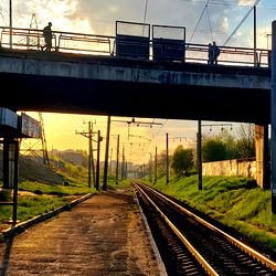 A tranquil scene at sunrise with a train crossing overpass