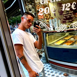 Young Man in Window Display of Bakery