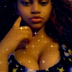 Angel from OnlyFans in a Space-themed Shirt, Posing with Resting Hand and Pensive Expression