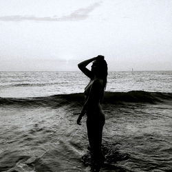 OnlyFans Model in Silhouette on Ocean Shore