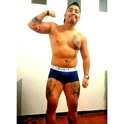 Model and Tattoo Artist Alex Showcasing Body Building Skills