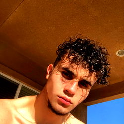 Young Man in Swim Shorts, Tattoo, and Piercing