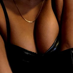 OnlyFans Model in a Busty Black Outfit with Leather Elements