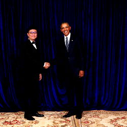 Chinese Tutor Posing with President Obama in 2015