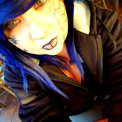 Stylized Portrait of a Young Female with Tattoos and Blue Hair