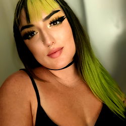 A Woman with Green Hair and Yellow Tint in Eyes, Posing for an Image