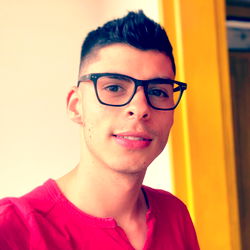 Andrés, 23-year-old male with glasses and a beard, taking a selfie