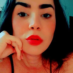 Andressa Haiek, a Brazilian beauty with bold red lips and striking eyebrows.